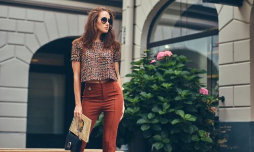 Beautiful fashionable brunette wearing trendy clothing and sunglasses.