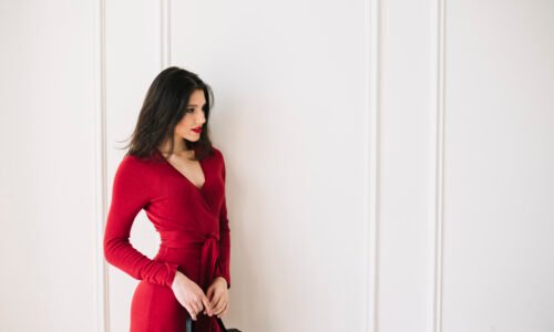 elegant-young-woman-red-dress-with-handbag-room